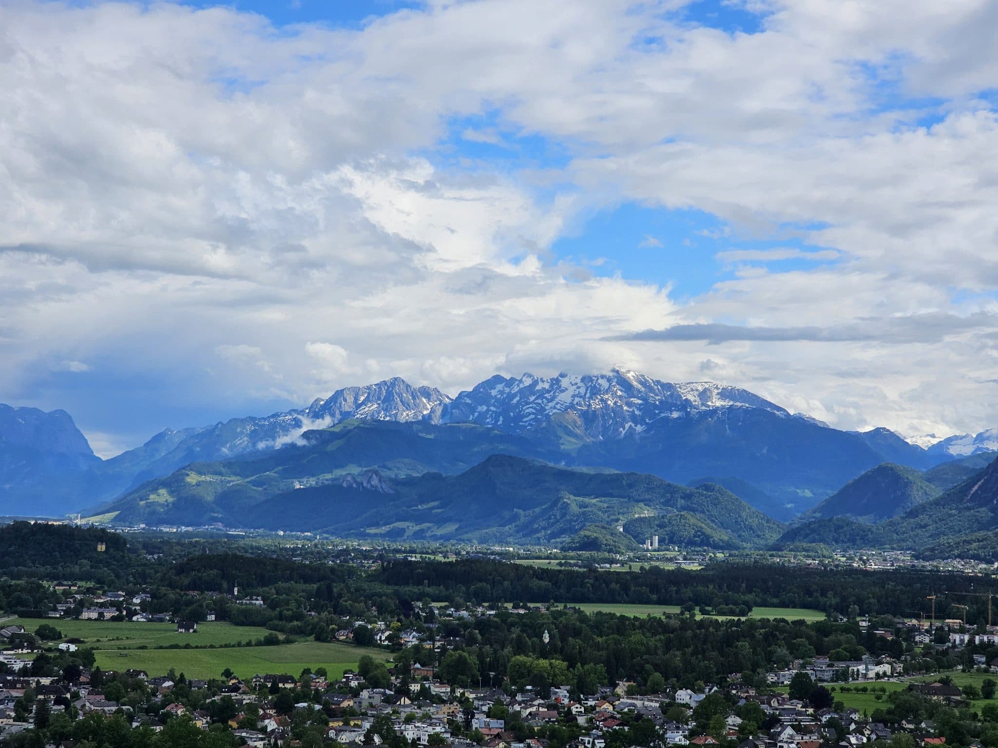 A landscape view of the snow-capped Alps in the distance